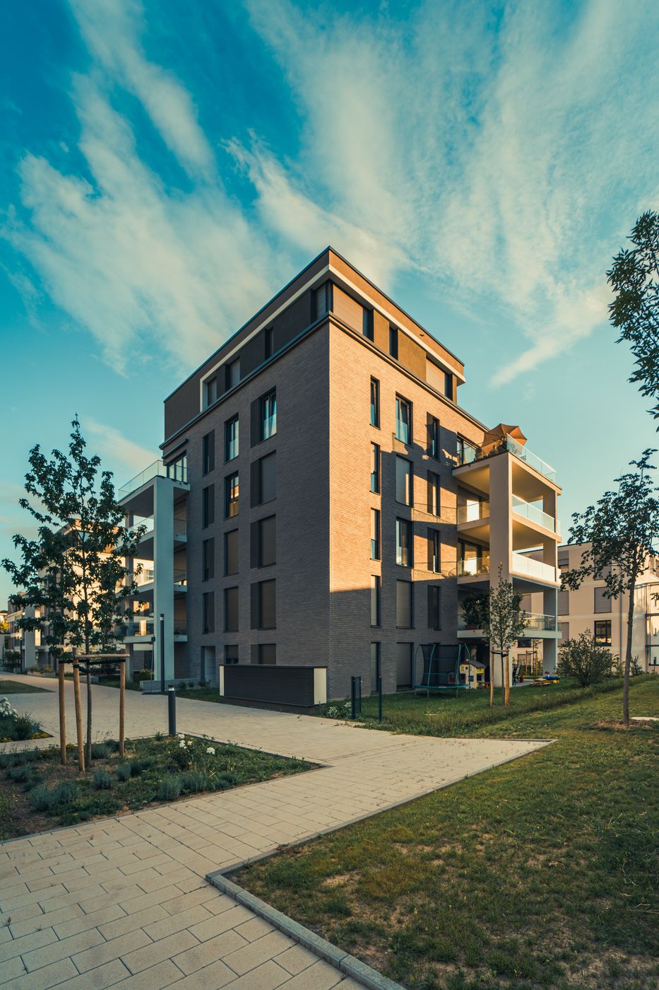 Newly built apartment building with a landscaped lawn